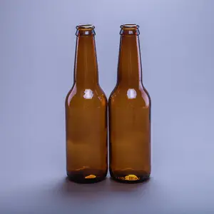 透明琥珀色または茶色のビール飲料ボトル空のグラス330mlガラスビールボトルクラウンキャップ付き