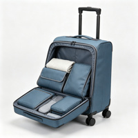 Valise souple pliable à roulettes en tissu bleu avec poches organisatrices frontales, poignée télescopique et protections d'angle