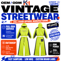 Ensemble de survêtement 2 pièces en molleton 500 GSM Acid Lime, comprenant un sweat à capuche court color block et un pantalon de survêtement à ourlet évasé à micro-clous, style streetwear, avec logo personnalisé