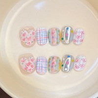 Ongles press-on faits main style niche, couleur macaron, motifs cœurs et nœuds, finition poudre miroir magique, lignes blanchissantes, amovibles