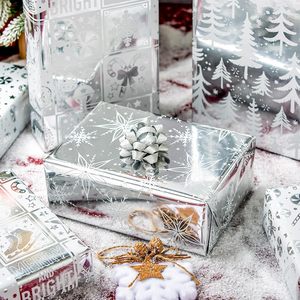 Papel de Regalo Navideño con Diseño de Copos de Nieve Plateados, Árboles de Navidad, Campanas, Dulces y Estrellas - Product Image 2