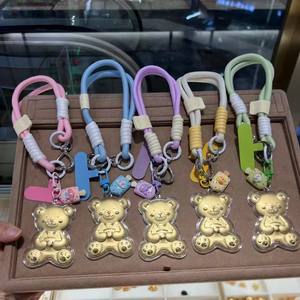 Llavero con correa de cuero y oro genuino de 24K, presentado con detalles decorativos de metal con motivos de dibujos animados. - Product Image 3