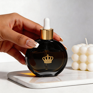 Botellas de Vidrio Redondas y Planas de 50 ml con Gotero, para Esencias Cosméticas y Lociones, Botellas con Gotero Doradas, Botellas Transparentes Negras Personalizadas con Caja de Empaque - Product Image 1
