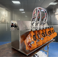 Machine de remplissage semi-automatique de table à quatre buses pour sachets à bec verseur et sachets verticaux (lait)