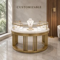 Vitrine à bijoux sur mesure en métal doré avec cadre incurvé et éclairage LED, idéale pour les centres commerciaux et la vente en gros