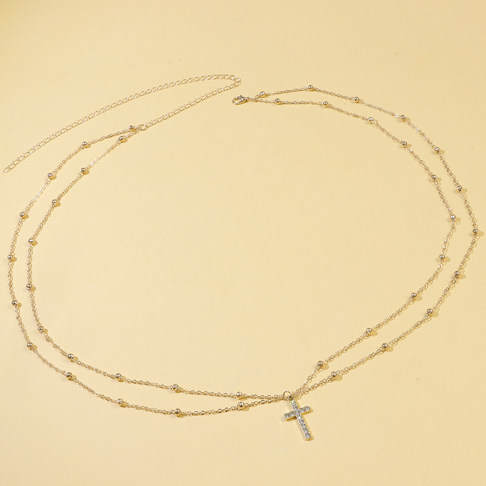 Cadena de cintura de doble capa con cruz dorada