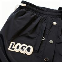 Pantalon évasé personnalisé en gros avec boutons-pression métalliques pour hommes, taille élastique, patch vintage brodé, coupe ample, streetwear décontracté