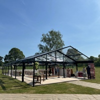 Tente de luxe noire avec parois latérales transparentes en PVC pour événements et banquets