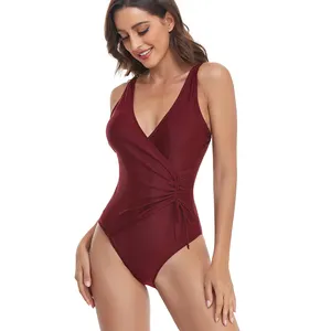 Venta de fábrica, último diseño, sólido, Sexy, lazo lateral, Bikini de una pieza, ropa de playa, cuello en V, traje de baño envolvente, traje de baño de Fitness estampado para mujer