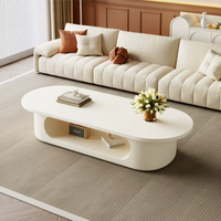 Table basse ovale blanc crème, base de rangement ouverte creuse, style minimaliste, profil bas, pour salon, table à thé