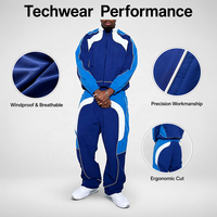 Survêtement de jogging en nylon réfléchissant 2 pièces avec logo personnalisé OEM/ODM, coupe-vent en nylon pour hommes avec bandes de finition blanches