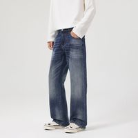 Jean large bleu foncé en denim délavé, coupe ample, taille mi-haute, style streetwear décontracté