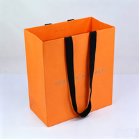 Sac en papier de luxe grande capacité pour vêtements et snacks, avec poignée en ruban orange personnalisée et votre propre logo