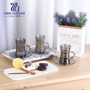 China supplier coffee cup sets with ion plating smoky grey color 105ml tea glass cup with saucer with different engraved shape