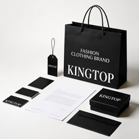 Boîte cadeau noire mate personnalisée avec sac shopping en papier, étiquette volante et enveloppe pour emballage de luxe de marque de vêtements de mode – Vente en gros