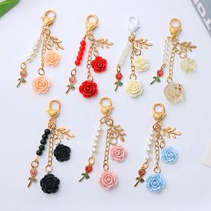 พวงกุญแจรูปดอกกุหลาบและดอกคามิเลียสำหรับแขวนกระเป๋า ผู้หญิง ดีไซน์หวาน ประดับมุก พู่ห้อย ใบไม้โลหะ ตกแต่งกระเป๋า อุปกรณ์ตกแต่งภายในรถยนต์ - Product Image 1