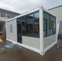 Maison conteneur préfabriquée modulaire en acier de 20 pieds avec mur rideau en verre pour bureau, studio, jardin, extérieur