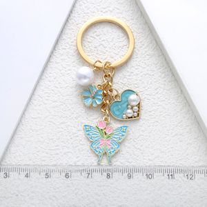 Porte-clés exquis en gros avec pendentifs papillon, fleur, coeur et perle - Product Image 4