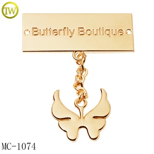 Etichette Metalliche Personalizzate per <span class=keywords><strong>Abbigliamento</strong></span>, <span class=keywords><strong>Accessori</strong></span> per Indumenti in Metallo Dorato con Logo a Farfalla - Product Image 1