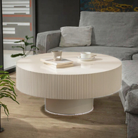 Table basse de style européen moderne, design tambour cannelé, plateau en pierre à bords embossés, structure en bois, piétement durable, table centrale blanche