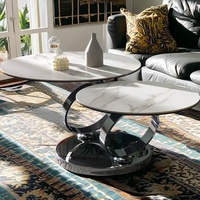 Meubles de maison d'hôtes modernes Cadre en acier inoxydable argenté rotatif Plateau rond en pierre frittée blanche Table basse