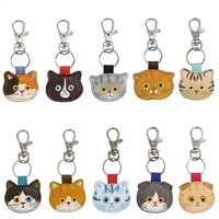 Breloque de sac en cuir PU durable en forme de tête de chat, porte-clés animal de dessin animé avec anneau à ressort métallique sécurisé pour ornement de sac à dos, vente en gros professionnelle