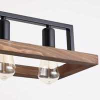 Luminaire suspendu de style industriel américain pour restaurant, en fer noir et bois massif, idéal pour bar et café.