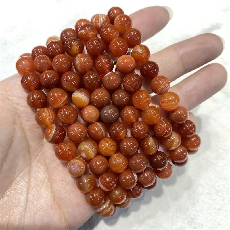 Usine en gros naturel poli agate rouge perles de pierres précieuses sculptures guérison cornaline bracelet en cristal rond pour cadeaux souvenirs