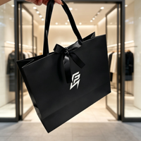 Sac cadeau de luxe noir personnalisé avec ruban en satin et logo imprimé, sac fourre-tout en papier pour boutique de vêtements, emballage de vente au détail