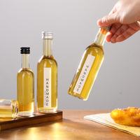 Bouteille en verre mini haute transparence de 50 ml et 100 ml avec étiquette personnalisée et bouchon en aluminium, conçue pour la bière, le brandy, les boissons énergisantes et le vin