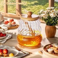 Vente en gros de bouteilles de stockage de logo personnalisé pots en verre de miel récipient en verre pour le miel