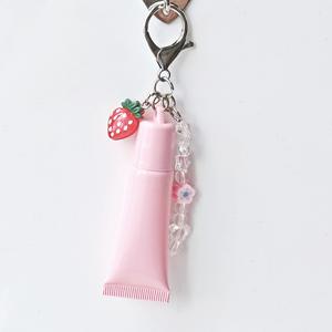 หลอดบีบลิปบาล์มแบบพลาสติกนิ่มขนาด 15 มล. พร้อมพวงกุญแจ สกรีนโลโก้ได้ บรรจุภัณฑ์พลาสติกสำหรับลิปออยล์ ลิปกลอส พร้อมหัวแปรงพลาสติก - Product Image 4