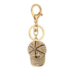 Wholesale of new cute hat keychains with diamond inlaid cartoon baseball caps, metal key pendants, and small commodities