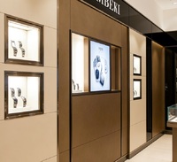 Comptoir d'îlot à montres multi-niveaux de luxe sur mesure, vitrine à bijoux en acier inoxydable premium avec éclairage LED, pour showroom personnalisé
