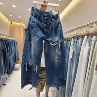 Nouvelle collection Hiver 2026 – Jean en denim pour femme, coupe large, taille double, délavé moyen, effet vieilli, avec patchs, ourlet balayant, style streetwear chic, vente en gros