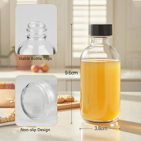 Mini bouteille en verre transparent de 60 ml (2 oz) avec bouchon à vis en plastique noir pour jus de gingembre, boissons énergétiques ou compléments alimentaires