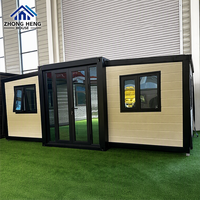 Maison conteneur modulaire préfabriquée moderne à double aile, avec auvent, fenêtre et porte vitrée, pour cabane de vacances à la plage ou au jardin, en acier extensible