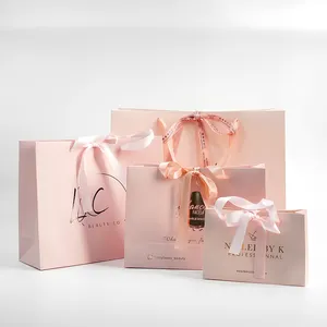Bolsa de regalo de embalaje de compras de papel de lujo de marca con logotipo de oro con impresión personalizada para ropa, joyería, color rosa con logotipo de oro rosa