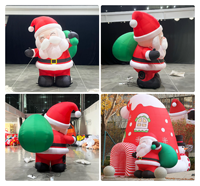 Père Noël souriant gonflable personnalisé portant un sac cadeau vert pour décorations de Noël gonflables