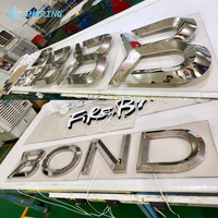 Enseigne personnalisée en lettres 3D en acier inoxydable chromé miroir rétroéclairées par LED pour la façade de magasin