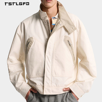Veste utilitaire en toile bleu marine personnalisée, col montant, fermeture éclair intégrale, poches doubles sur la poitrine, poignets ajustables à l'avant, unisexe