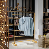 Présentoir pliable moderne et personnalisable en acier inoxydable doré brillant pour vêtements de magasin de détail, idéal pour les boutiques de prêt-à-porter féminin et les usines.