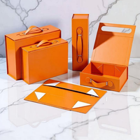 Boîte d'emballage magnétique pliable de luxe couleur orange avec poignée en cuir PU, matériaux recyclés, pelliculage mat, haut de gamme
