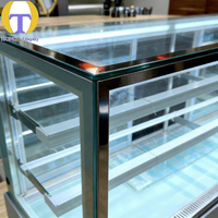 Vitrine à gâteaux moderne de luxe en verre trempé avec éclairage LED, robuste et personnalisable pour les magasins de détail et les centres commerciaux