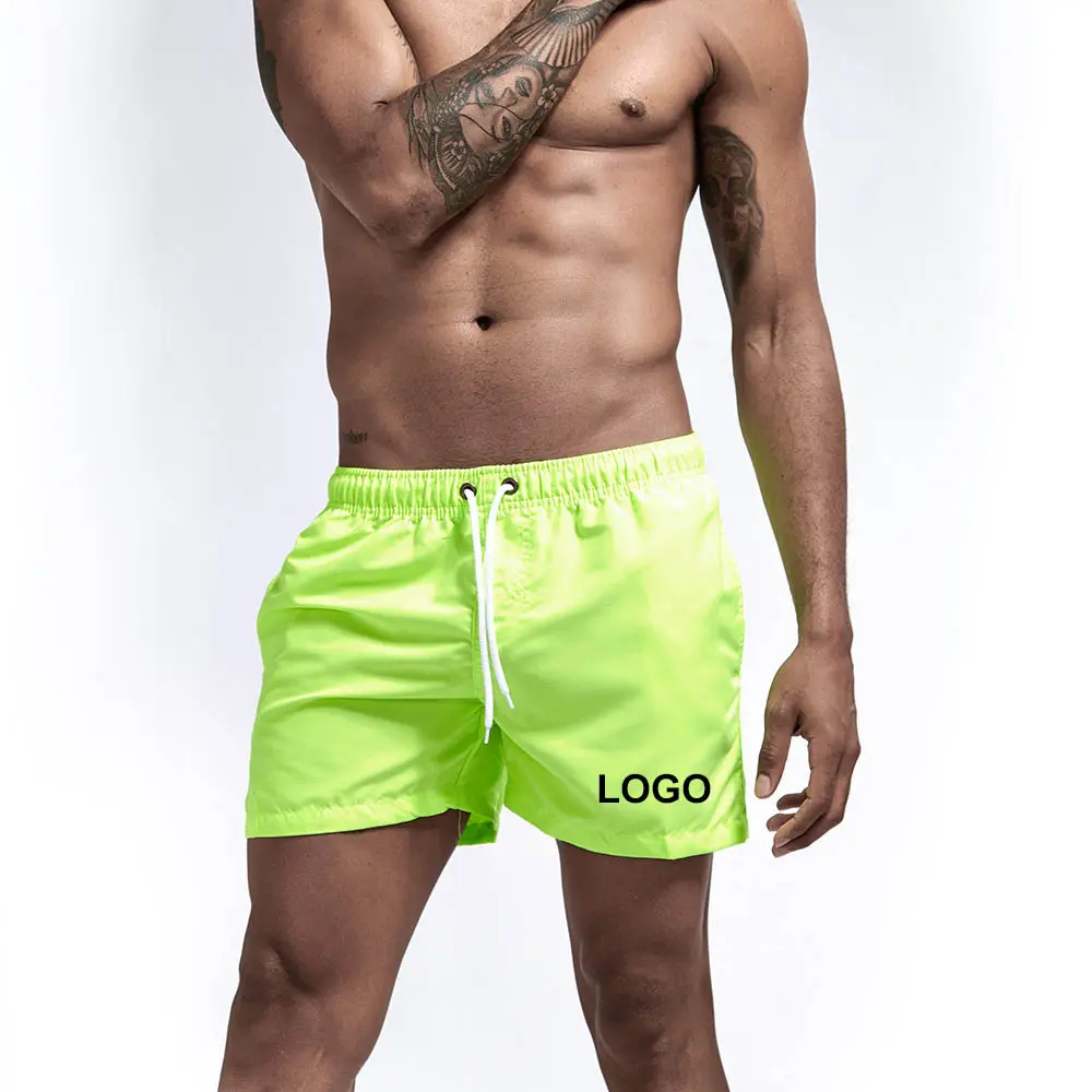 Cueca de praia para homens, china fábrica preço barato personalizado logotipo mens roupa de banho sólida praia calças masculinas neon verde maiô sem logotipo