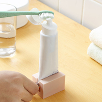 TX vente en gros ménage Portable dentifrice Tube roulant presse-agrumes salle de bain distributeur de dentifrice