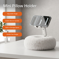 Ajustable à 360° °   Support de téléphone flexible en forme de coussin avec design en peluche, adapté pour une utilisation sur un lit ou une table.