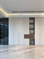 Revêtement mural blanc minimaliste combiné à des vitrines en verre, des étagères ouvertes et des bandes lumineuses LED créant un design de rangement.