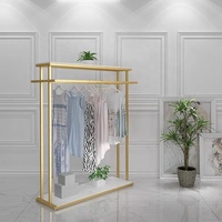 Étagère de présentation pour magasin de vêtements, design neuf, en acier inoxydable brillant doré, avec base.