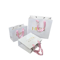 Sac cadeau en papier texturé blanc aseptique écologique imprimé sur mesure avec poignée longue, sac de shopping de luxe OEM pour boutique